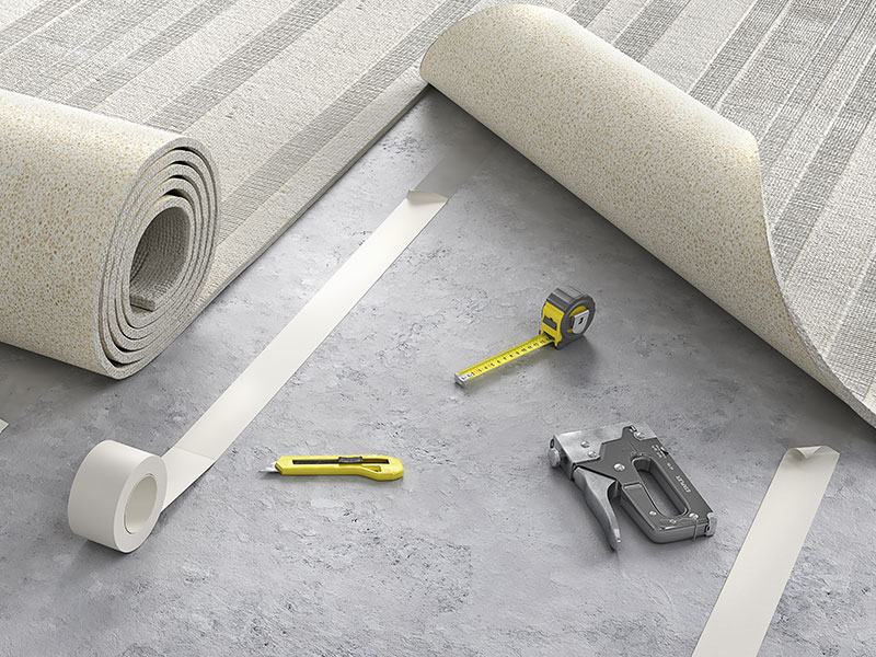Carpet seam repair with carpet, tape measure and other tools shown