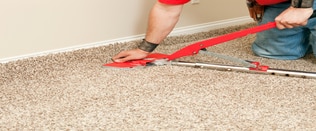 Carpet stretching with a tool for taut carpet.