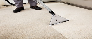 Close-up Of A Person Cleaning a Carpet